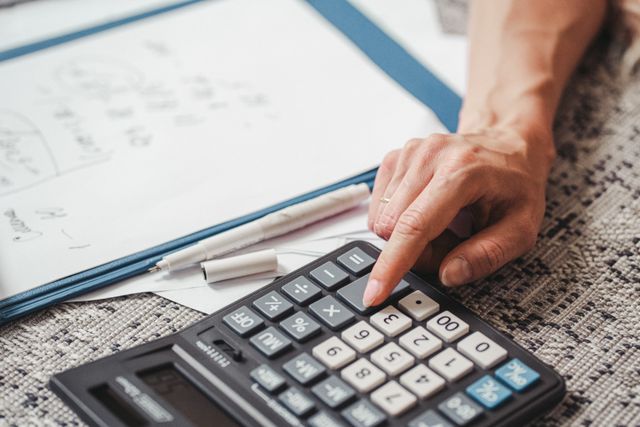 a hand using a calculator